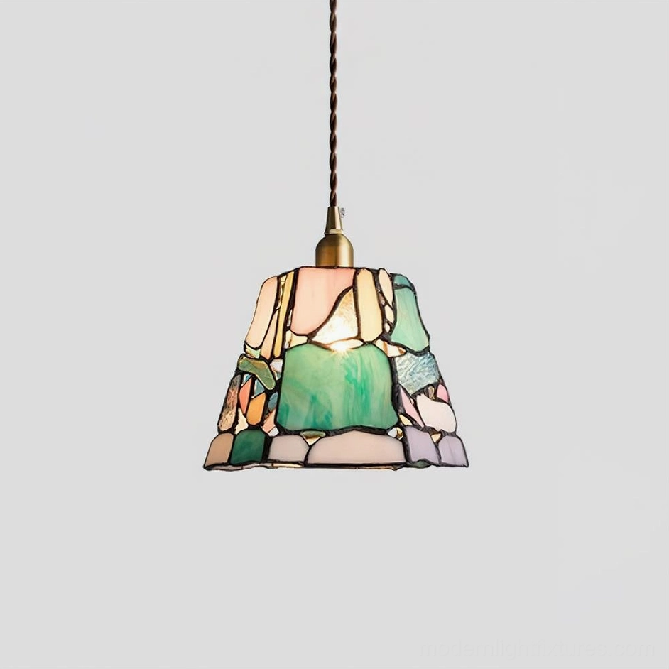 Artisan stained glass pendant fixture with prominent green glass panel, trapezoid shade, frontal studio view