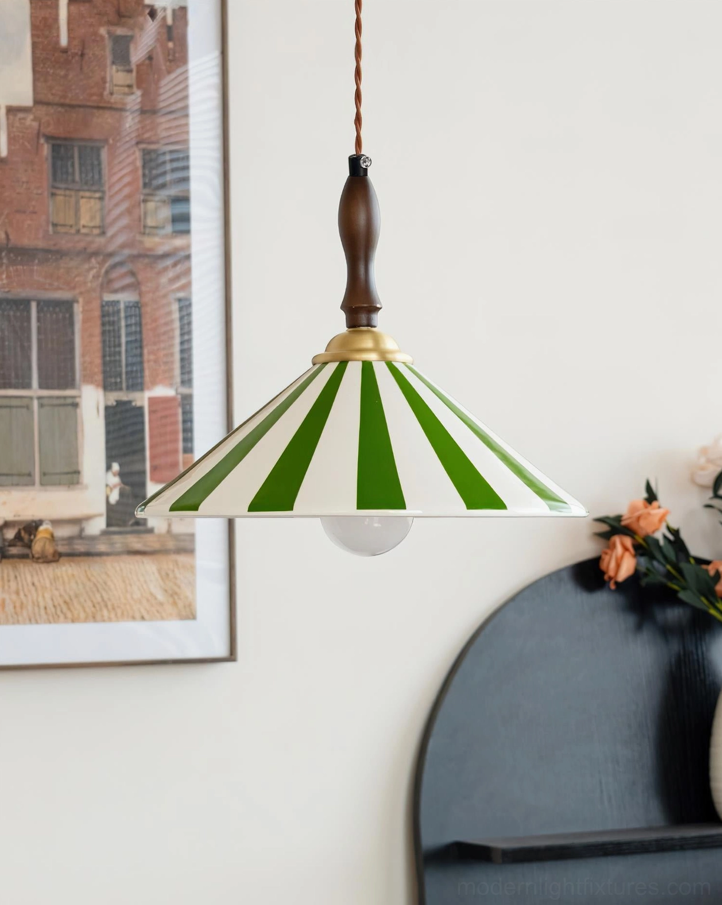 Green and white striped hand-painted ceramic pendant light with brass accents and wooden hardware in home corner with decorative shelf