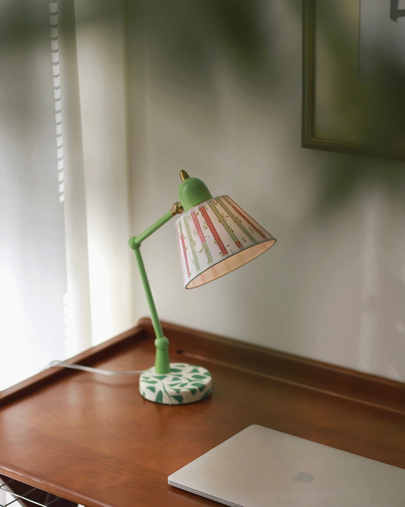 Adjustable green table lamp showcasing articulated arm design with artistic striped fabric lampshade