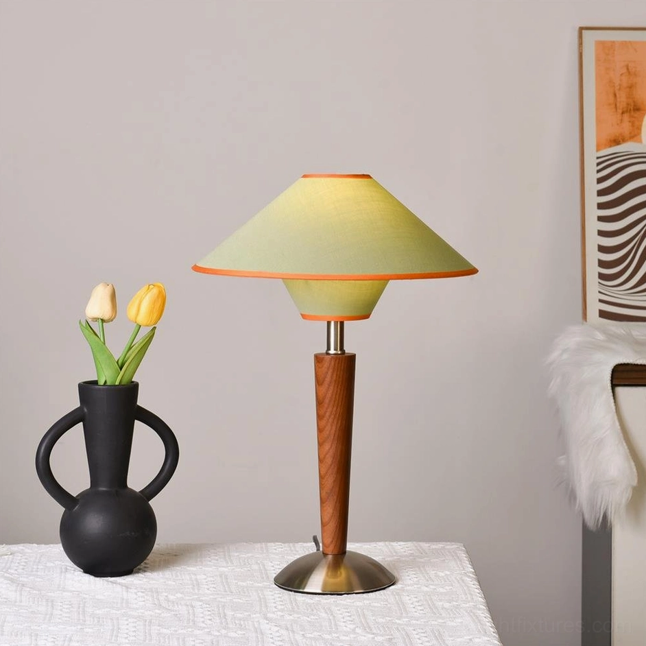 Green fabric shade mid-century table lamp with wooden stem and metal base close-up product detail view