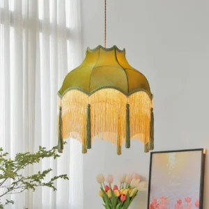 Green velvet tassel chandelier displayed in bright living room with plants and artwork
