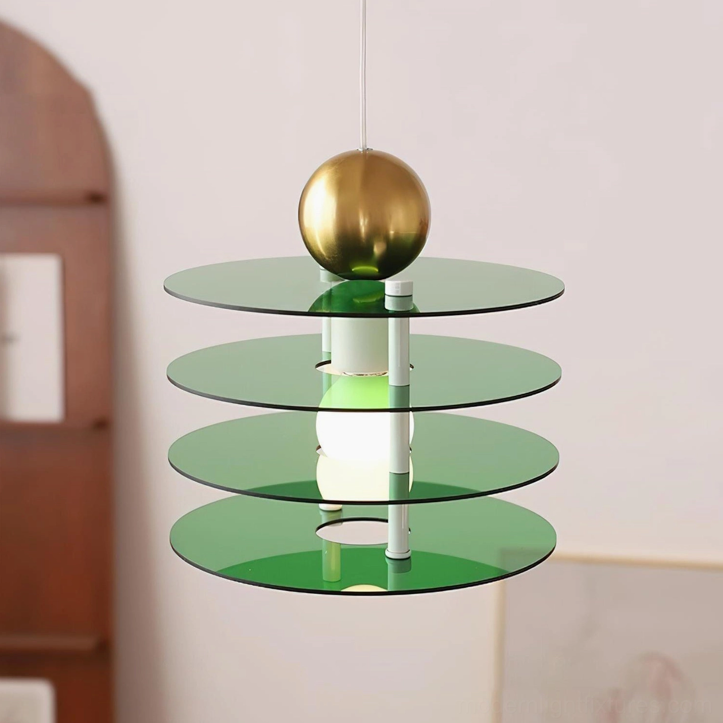 Green tiered pendant light with gold accent sphere and acrylic disc shades