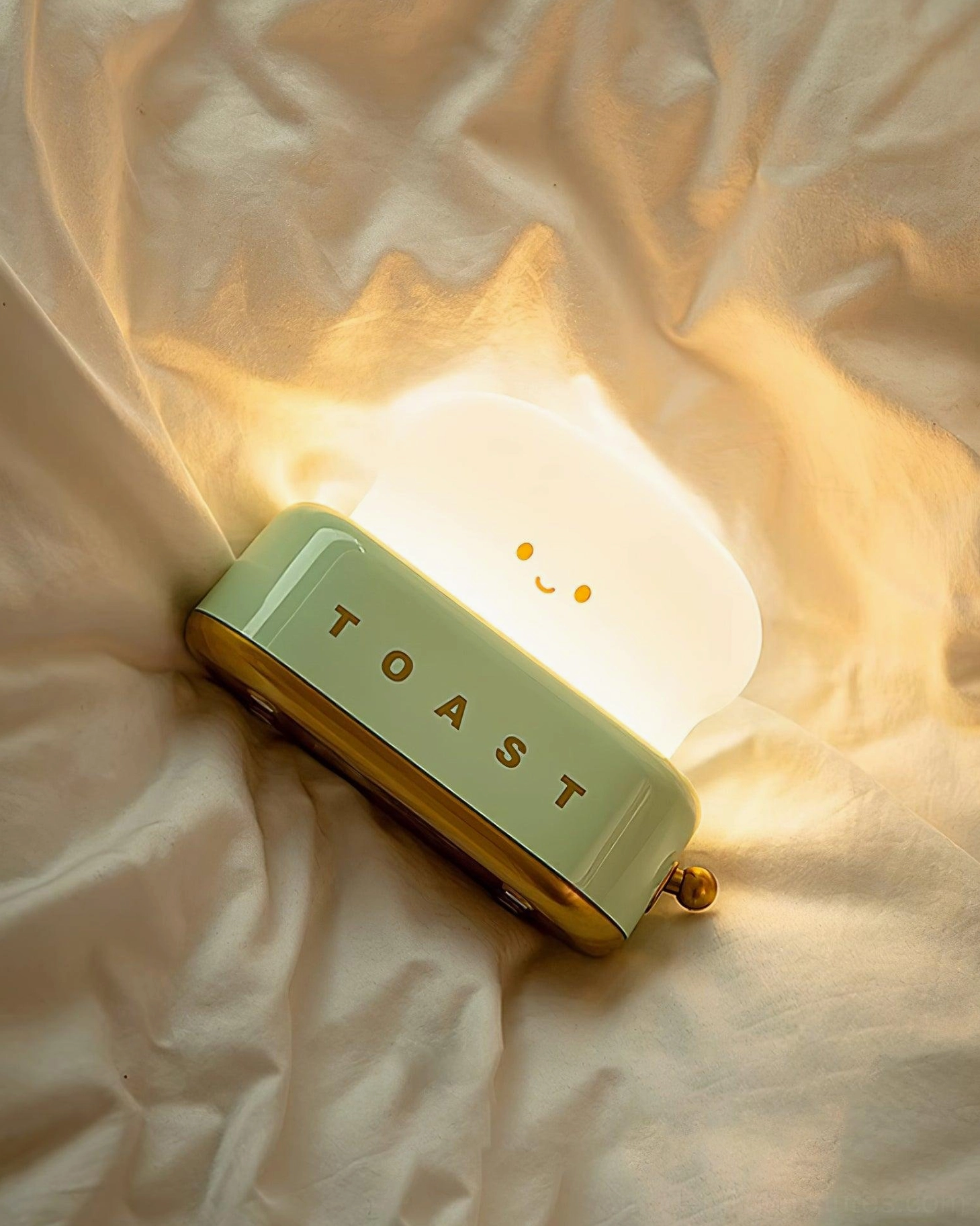 Green toaster table lamp as decorative accent piece on bookshelf with curated styling