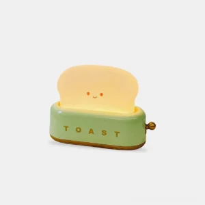 Retro toaster table lamp with green finish and brass knob, front studio view showing warm LED light output