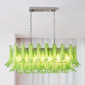 Illuminated green tulip leaf chandelier casting warm light through glass pendants in contemporary interior