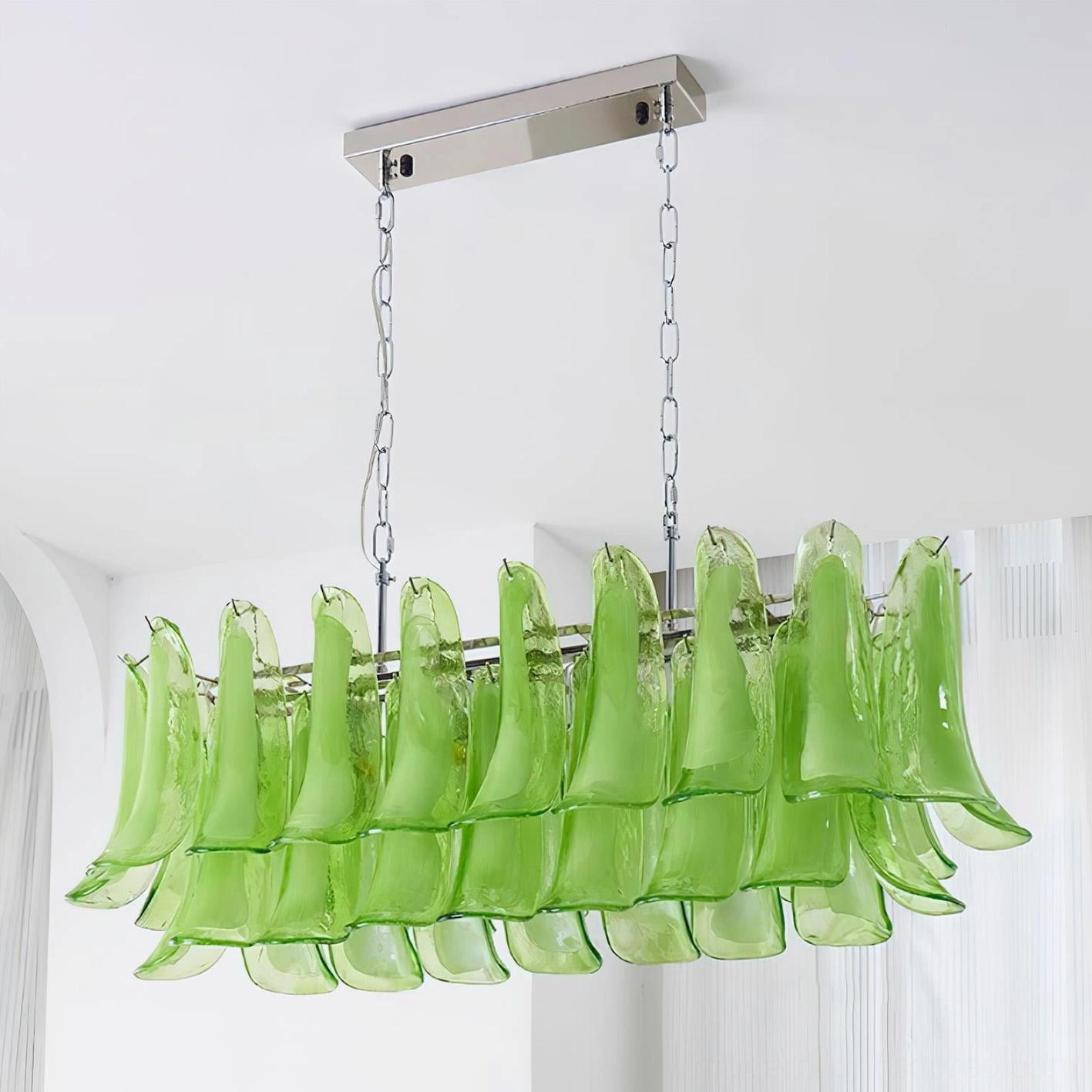 Side view of green tulip leaf chandelier showing dual hanging chains and petal-shaped glass elements