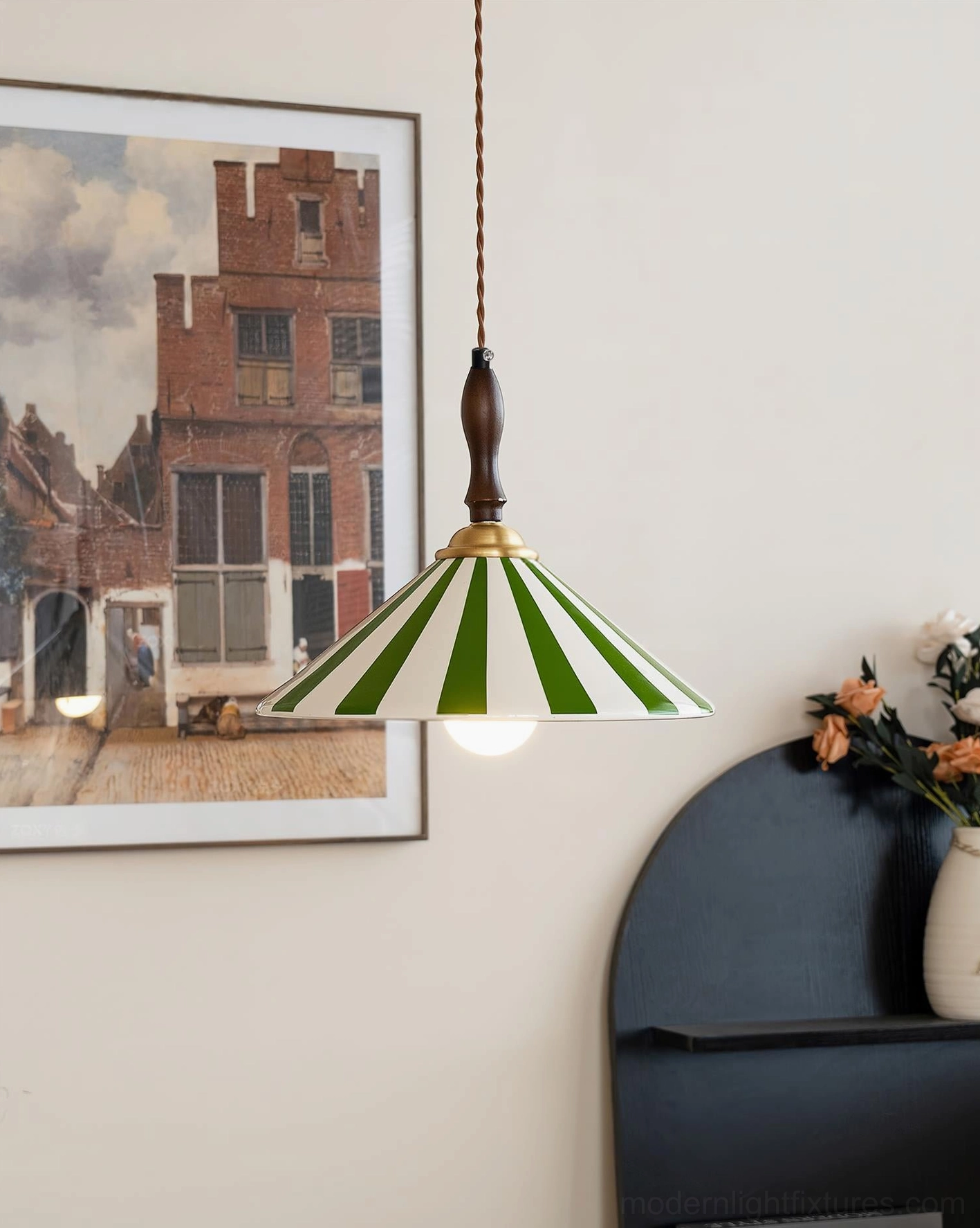 Green striped vintage pendant light with illuminated exposed bulb and artisan hand-painted ceramic shade in country style home decor