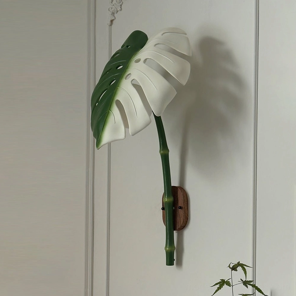Green and white monstera leaf wall sconce two-tone design for contemporary home styling