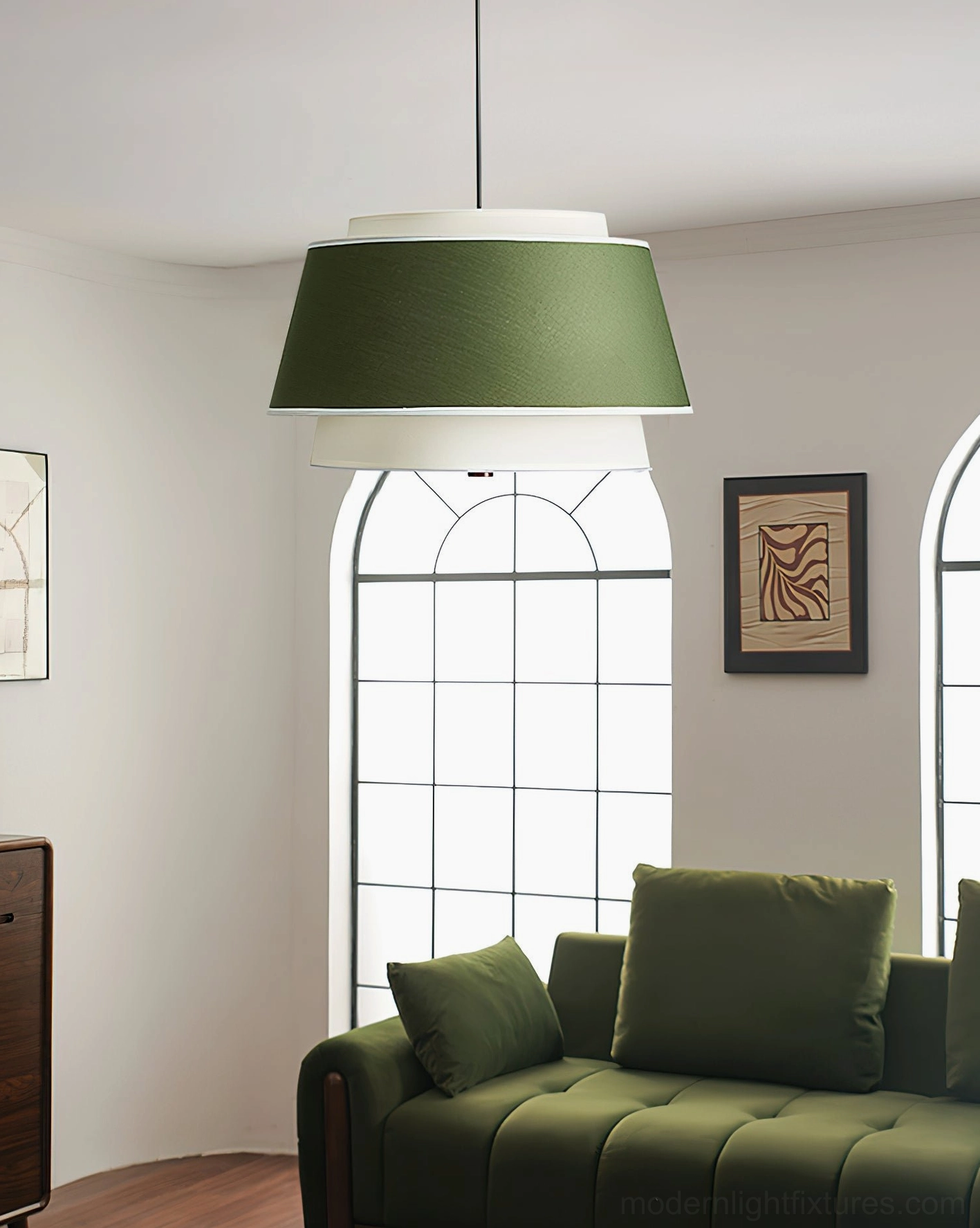 Green and white tiered pendant light hanging in modern living room with velvet sofa interior design