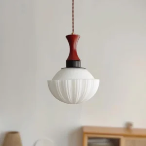 Greta ribbed glass pendant light hanging in minimalist interior with wooden cabinet background