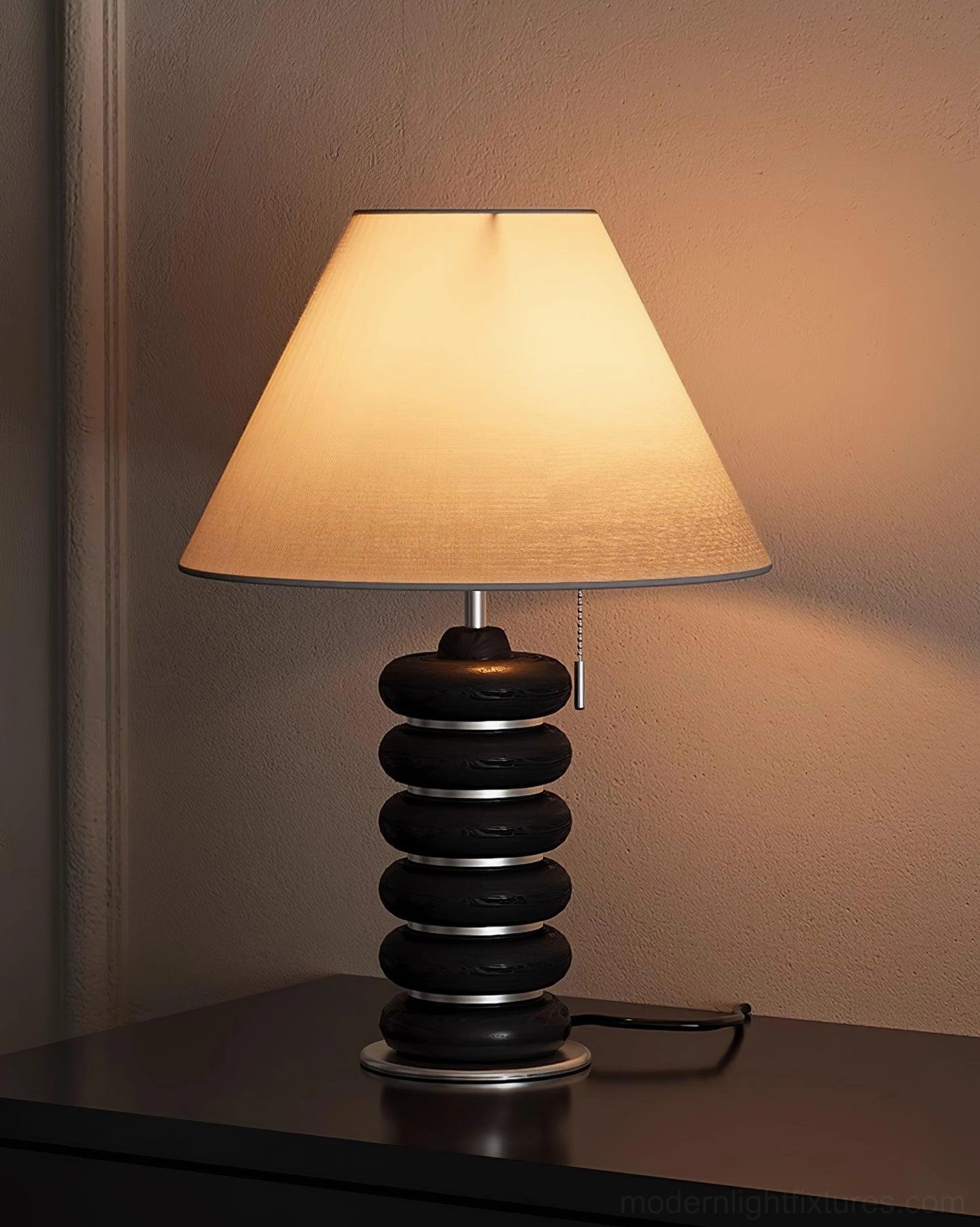Black stacked disc table lamp bedroom ambient nightstand warm wall lighting scene