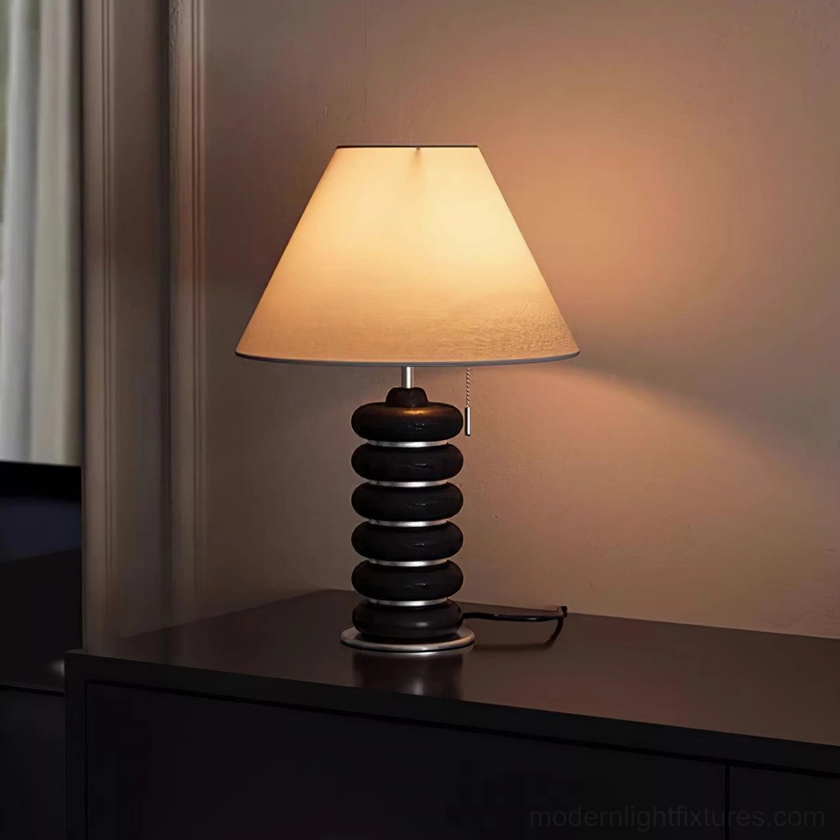 Dark walnut stacked wood table lamp bedroom nightstand scene with black disc base and silver metal trim