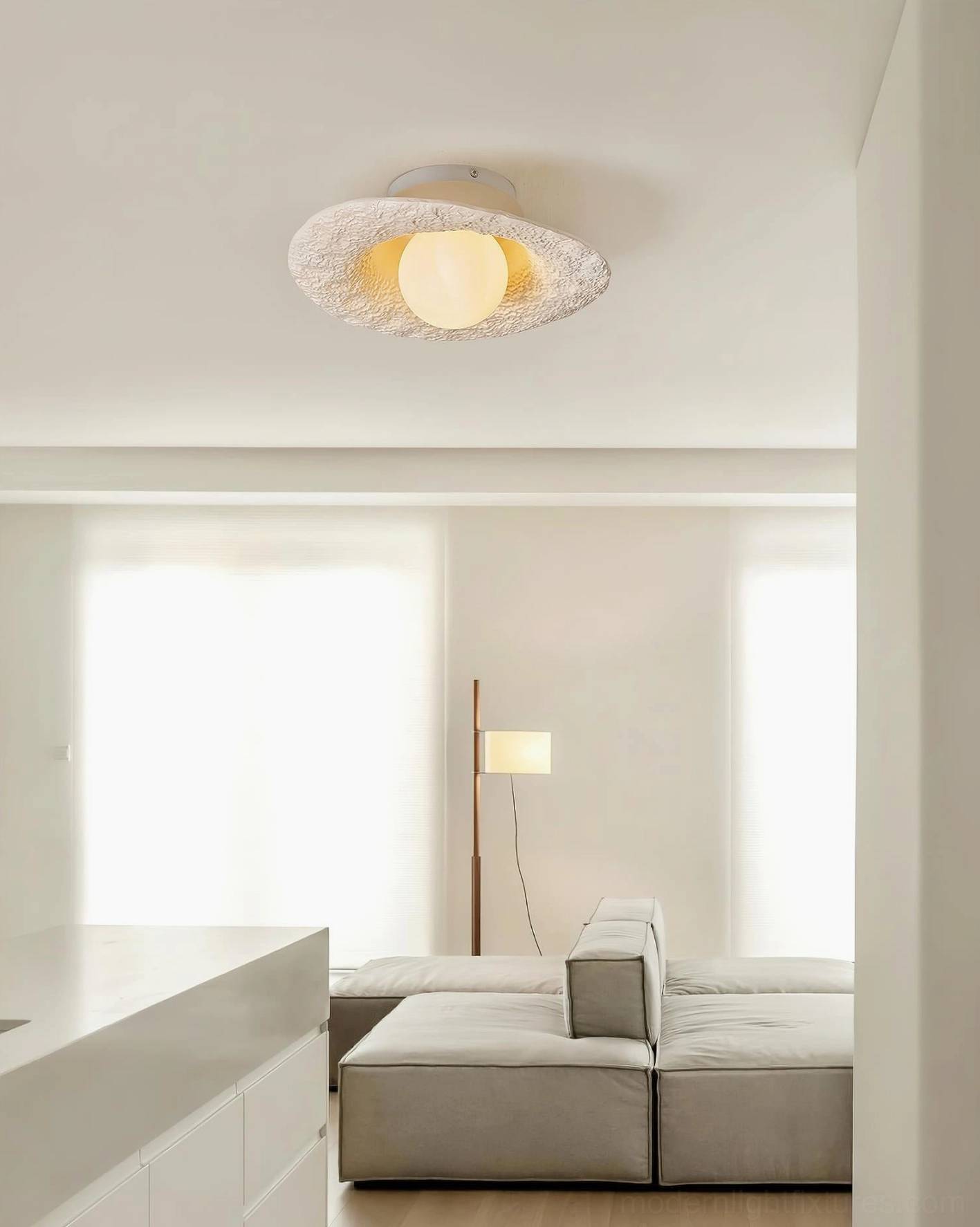 Grima hat ceiling light mounted in modern minimalist living room with off-white textured brim and ambient lighting