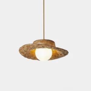 Grima hat-style pendant light with brown textured shade, studio close-up view with warm white bulb