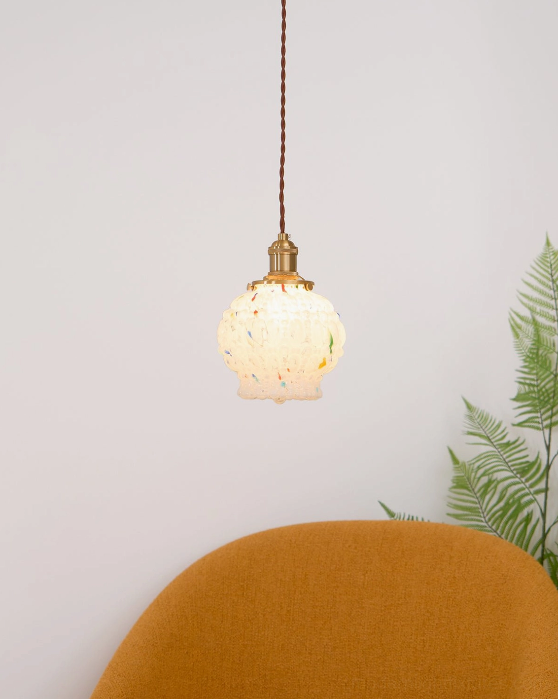 Grouped Kano Bubbles glass pendant lights at varying heights, modern boho interior with natural wood and textiles, focal point