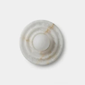 Grove Alabaster Wall Sconce - overhead flat lay showing ripple-carved natural alabaster disc with frosted glass globe diffuser