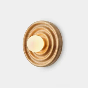 Grove spiral wood wall sconce with frosted glass diffuser, front view showing concentric ring pattern on natural ash wood