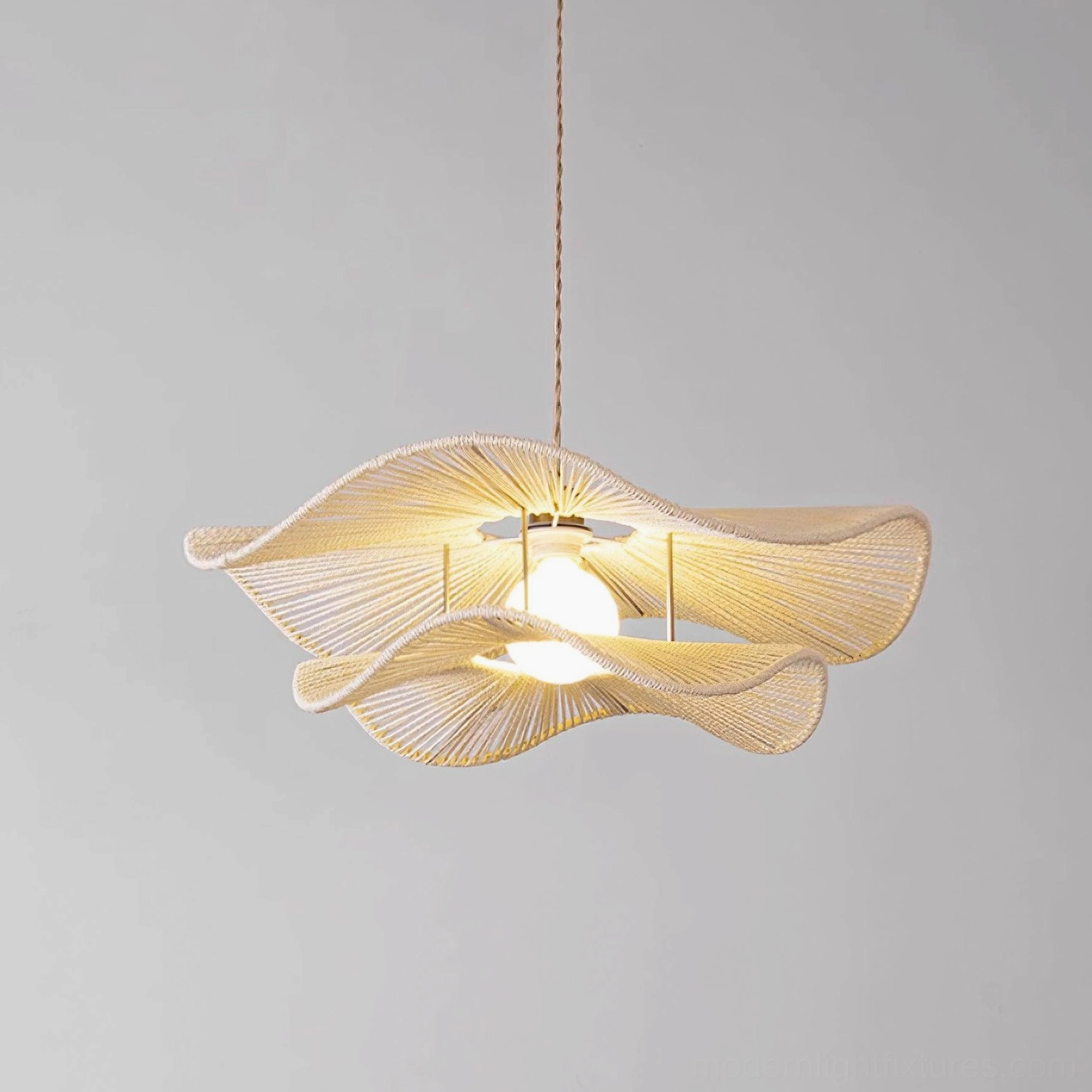 Gunilla off-white minimalist bohemian woven hemp rope pendant light in studio with beige natural fiber texture