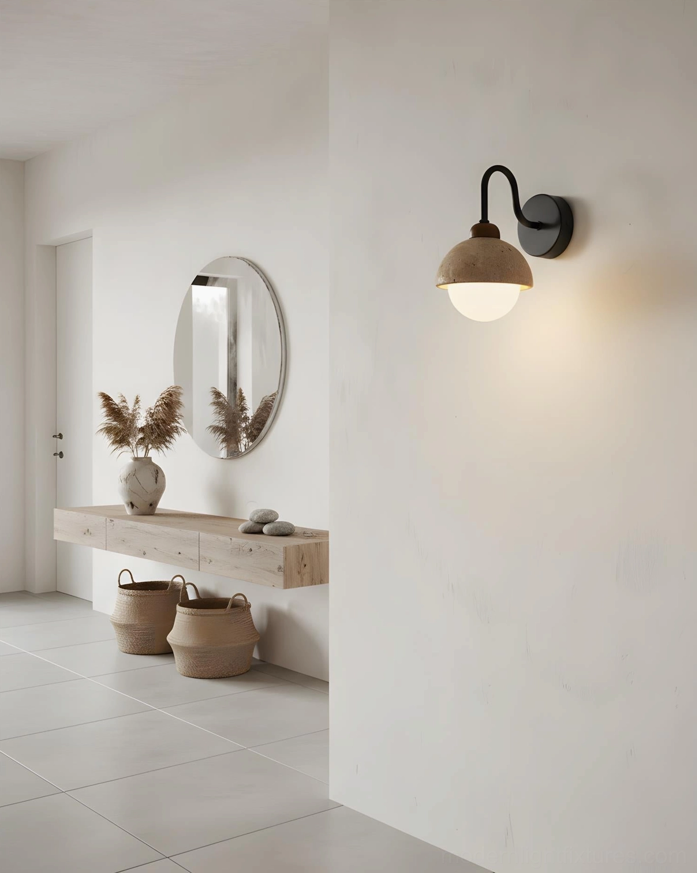 Single Halcyon Dome Wall Sconce with curved black arm mounted in minimalist hallway, architectural lighting detail