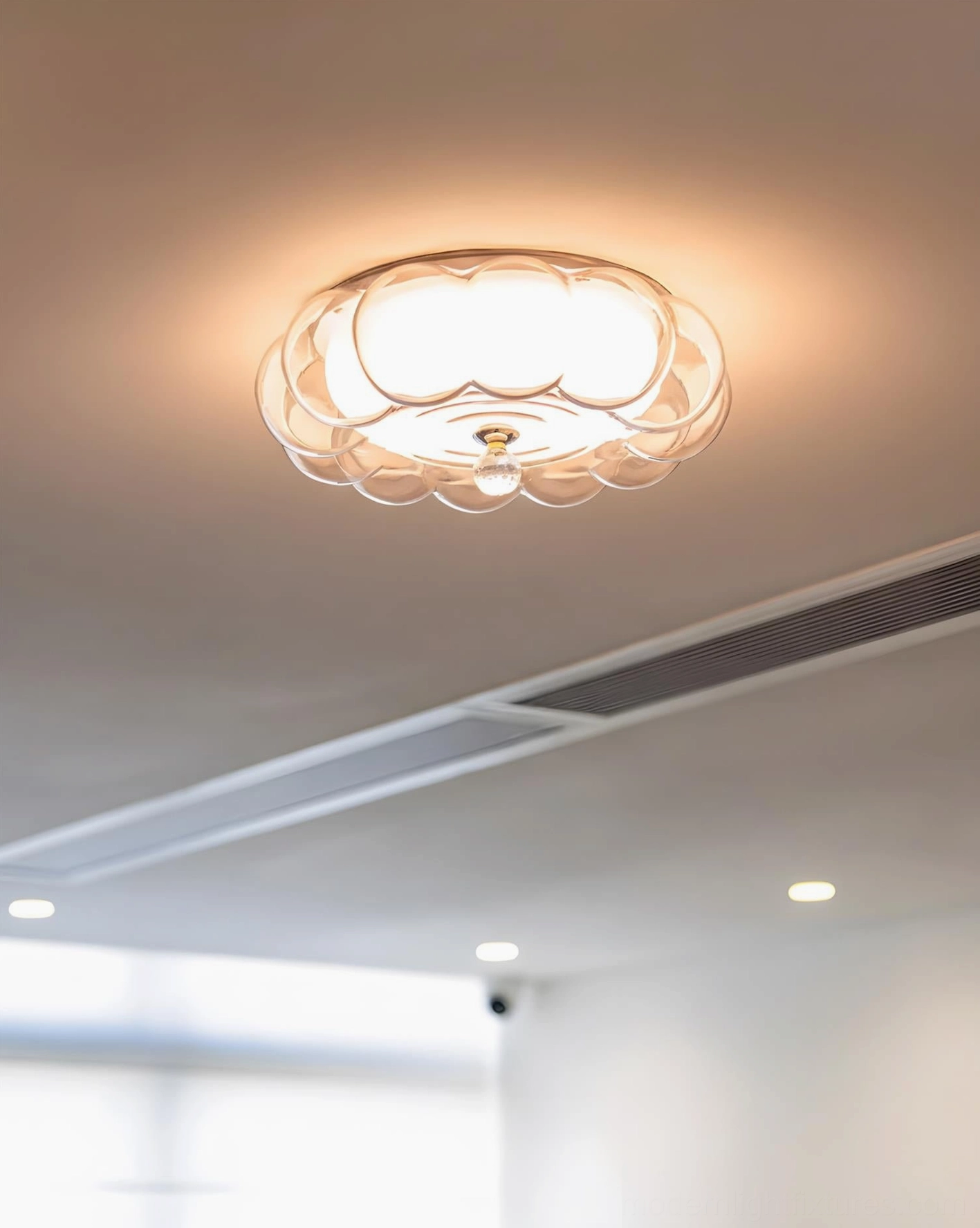 Cream pumpkin-shaped glass ceiling light creating warm glowing ambiance, installed in bright living room ceiling space