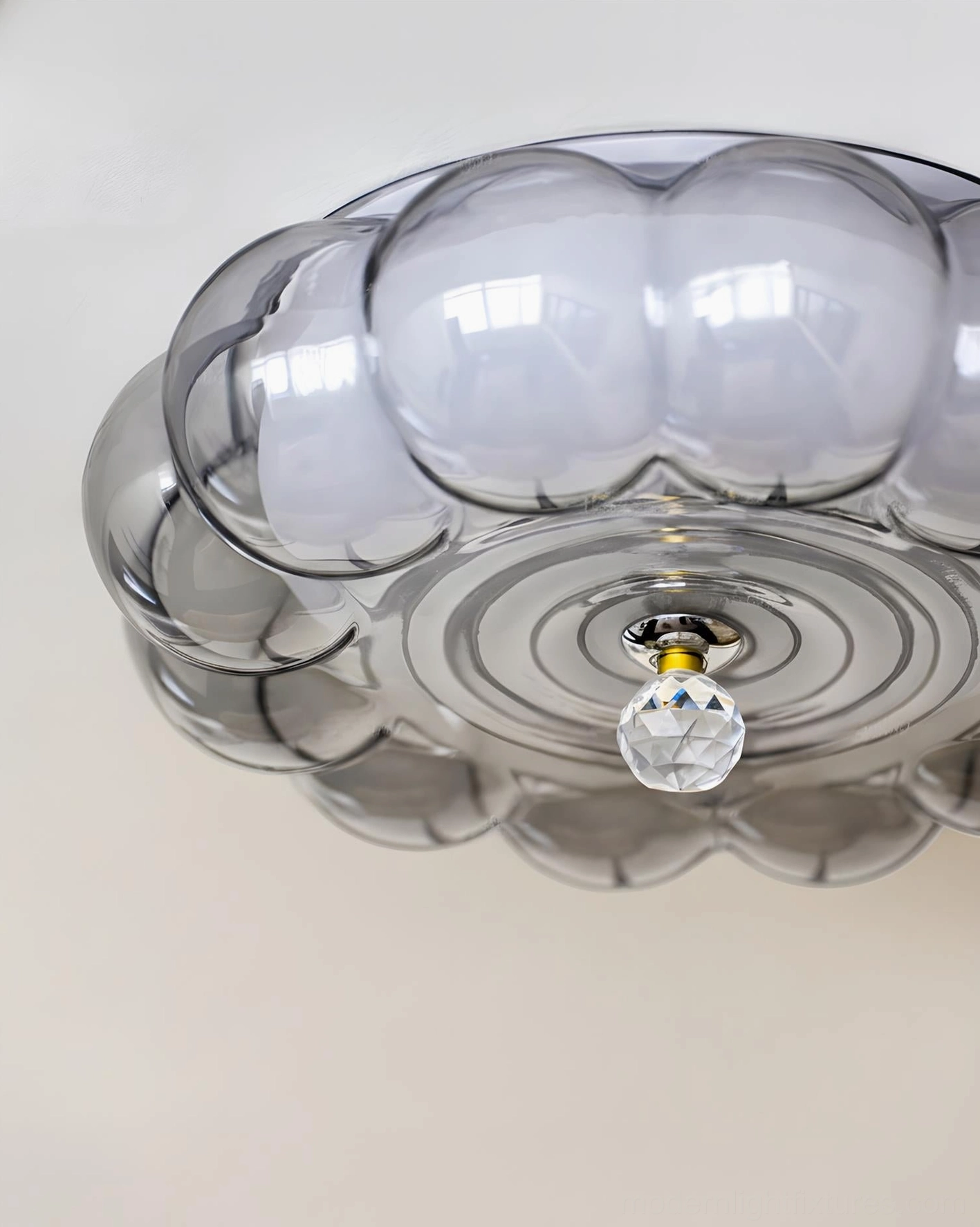 Close-up bottom-up view of Hallowmere glass ceiling light showing detailed segmented pumpkin texture, gold-toned fixture and crystal pendant