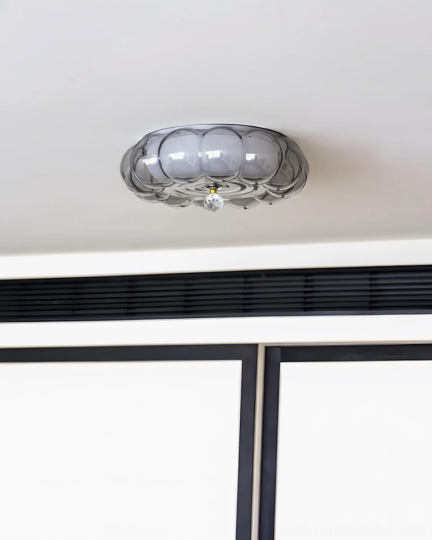 Overhead top-down view of Hallowmere ceiling light fixture installed on residential ceiling, compact pumpkin-shaped glass form