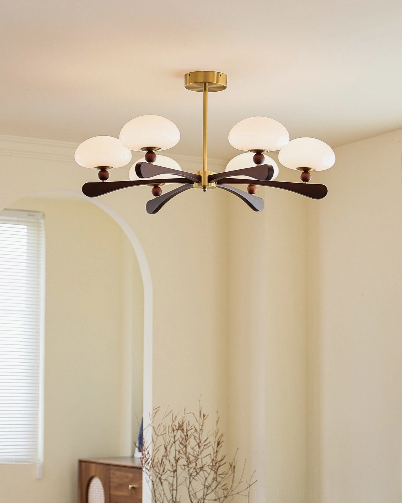 6-light radial chandelier with walnut-stained ash wood arms installed in narrow warm hallway, simple neutral home style