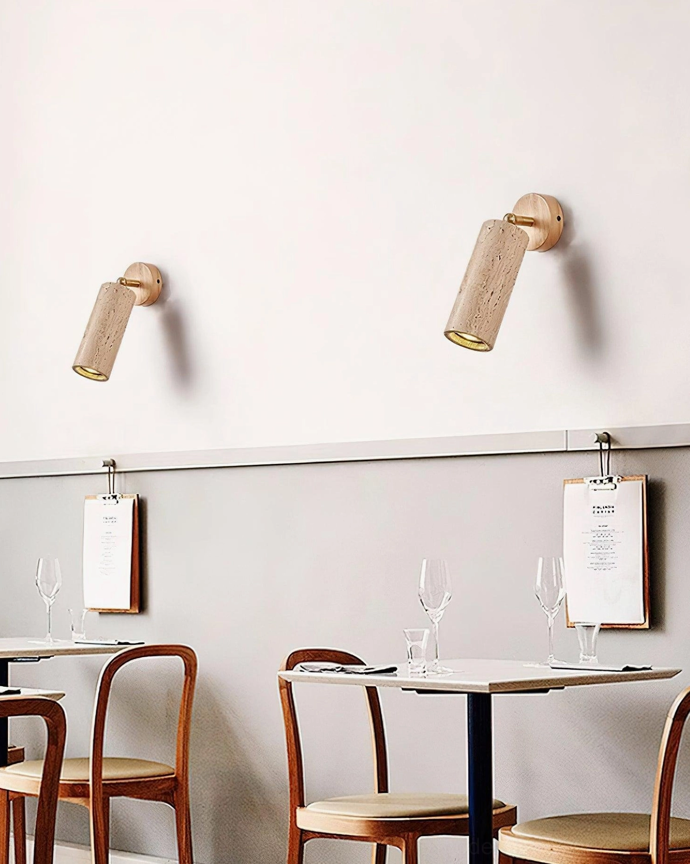 Mireille travertine wall sconce installed in hallway with soft ambient warm light and elegant profile