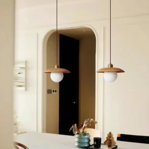 Modern oak pendant light installed in residential dining room above wooden table with warm ambient lighting