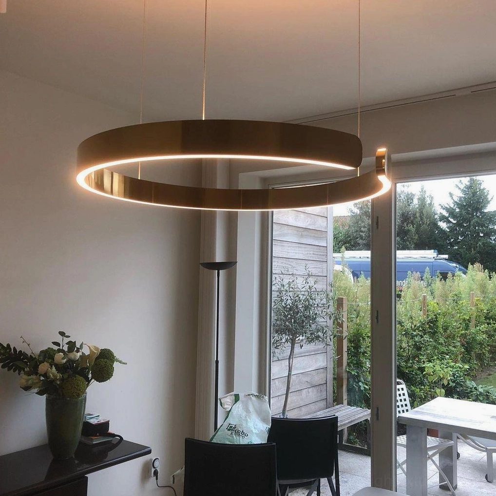 Multiple halo ring pendant lights installed at varying heights for dynamic modern design effect