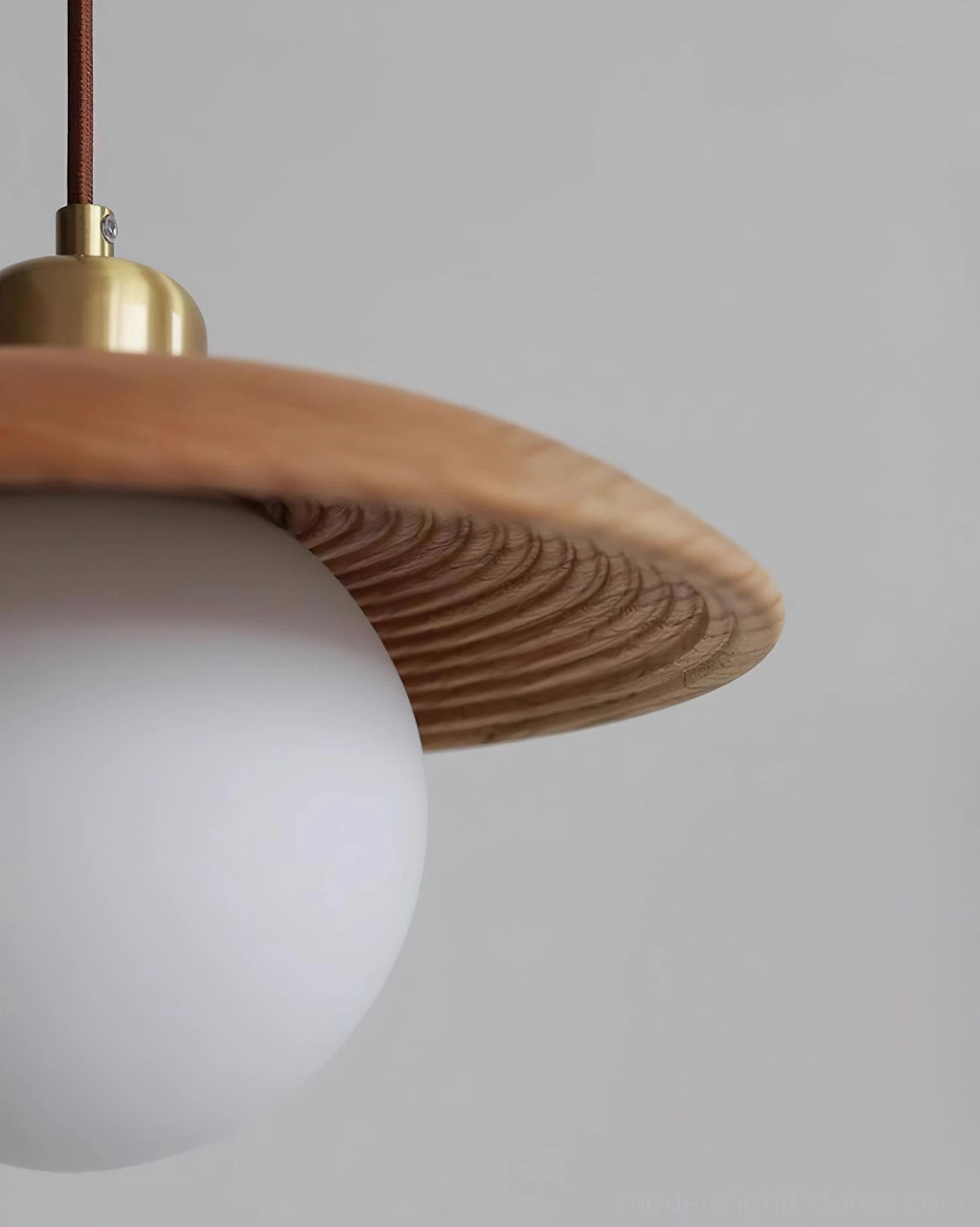 Dark walnut wood globe pendant light low-angle side view highlighting inner wood grain