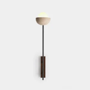 Halvo modern travertine wall sconce with black metal stem and hemispherical stone shade in studio setting