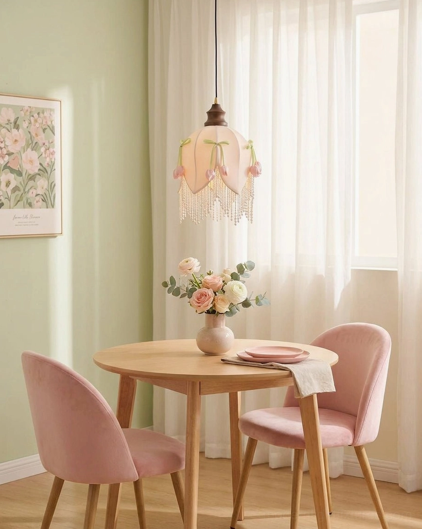 Hanavelle pendant light hanging in minimalist green-walled dining space with pink velvet seating, wooden round table, contemporary cottagecore interior