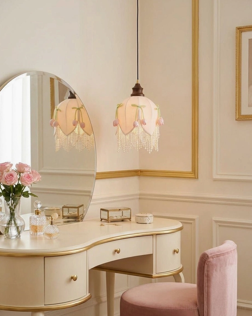 Hanavelle fabric tulip pendant shade close-up highlighting petal seaming, cream color, pearl-bead fringe trim, and hand-applied green velvet bows and pink tulip buds