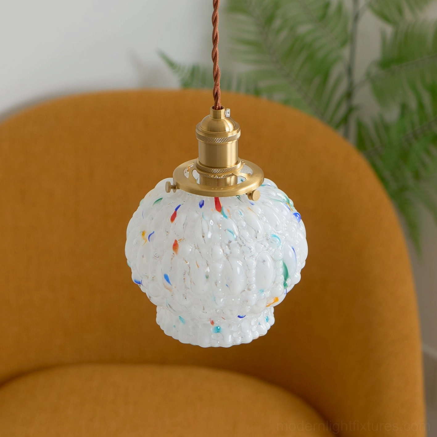 Hand-blown glass bubble pendant light creating layered ambient lighting effect, contemporary interior styling with warm tone