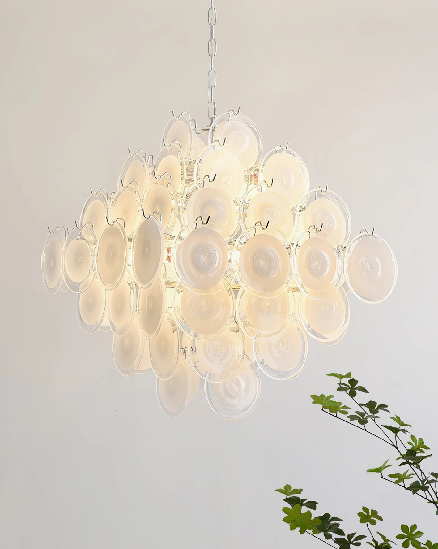 Contemporary hand-blown glass disc chandelier elegant hallway view emphasizing artistic focal point presence