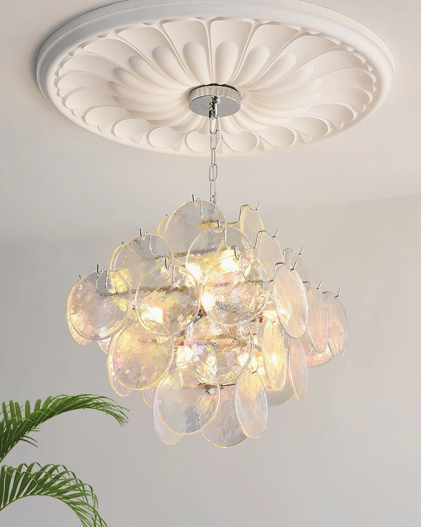 Hand-blown glass disc chandelier master bedroom suite view establishing elegant personal sanctuary lighting