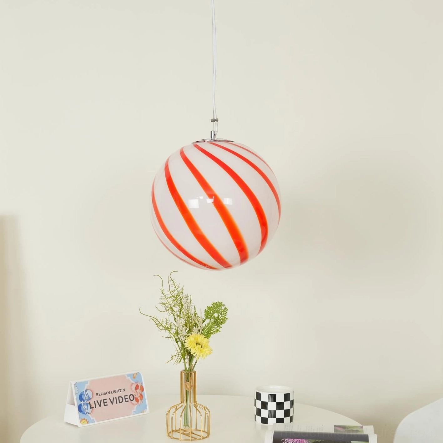 Hand-blown spiral stripe pendant lamp illuminated, demonstrating warm ambient lighting and light diffusion through glass