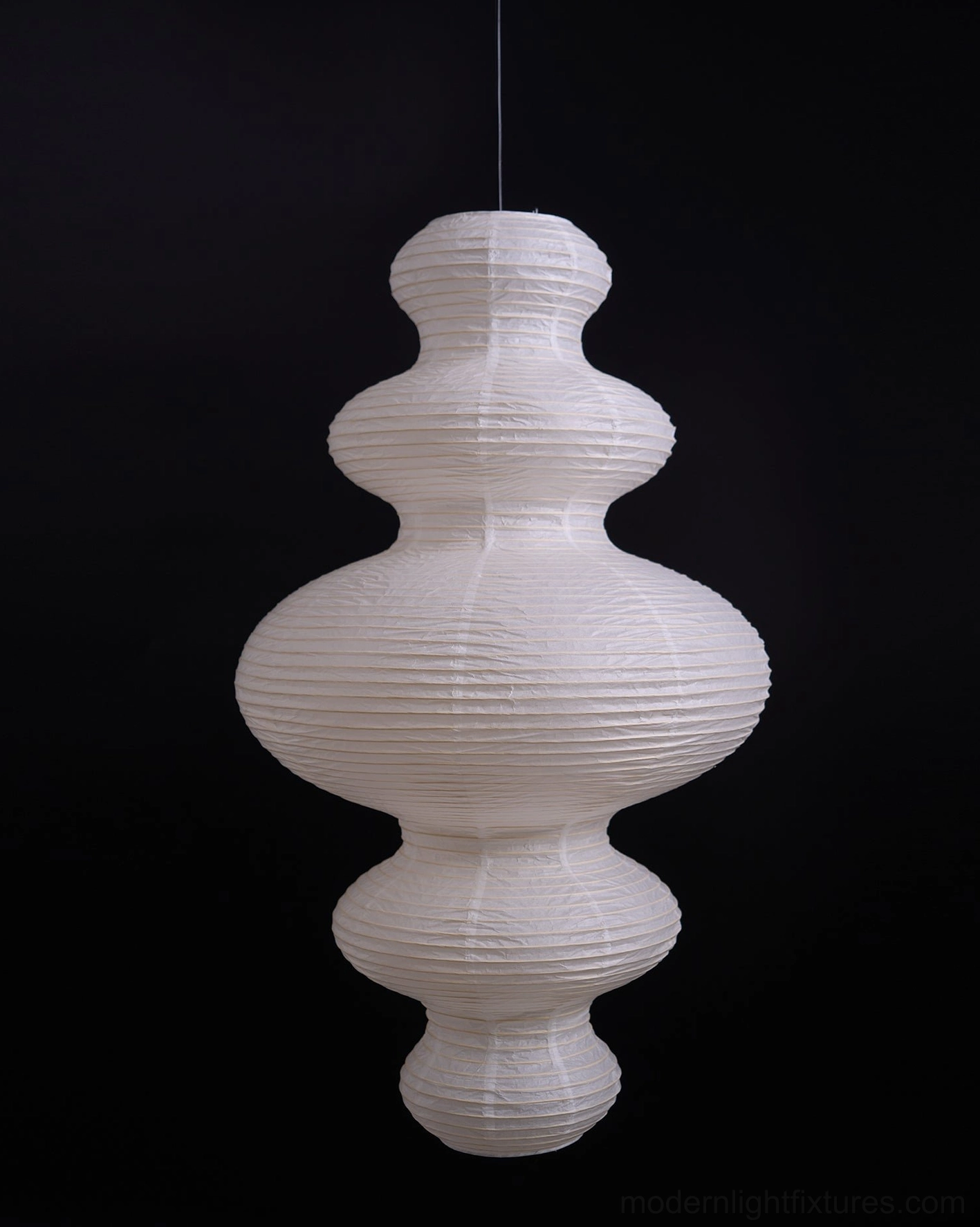 Hand-crafted pendant lamp with translucent rice paper creating subtle light shadow gradations