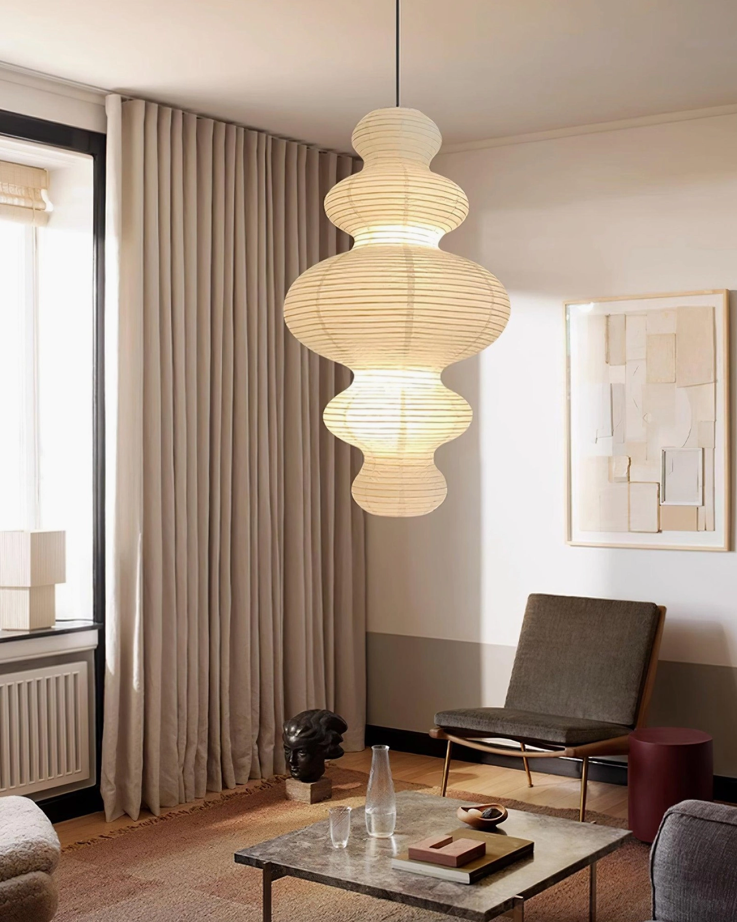 Warm light glowing through hand-crafted white rice paper pendant shade showing diffusion quality