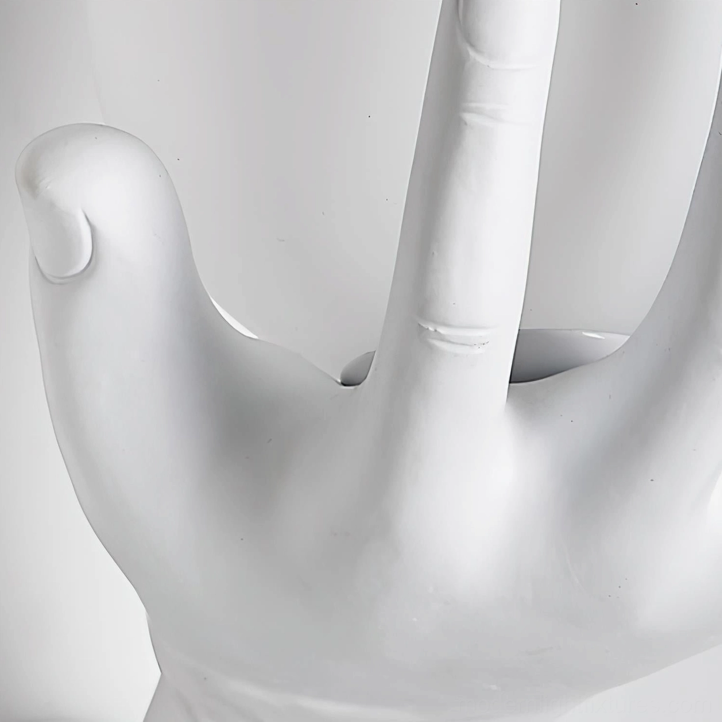 Hand of Victory wall sconce angled view showing hand gesture and globe illumination