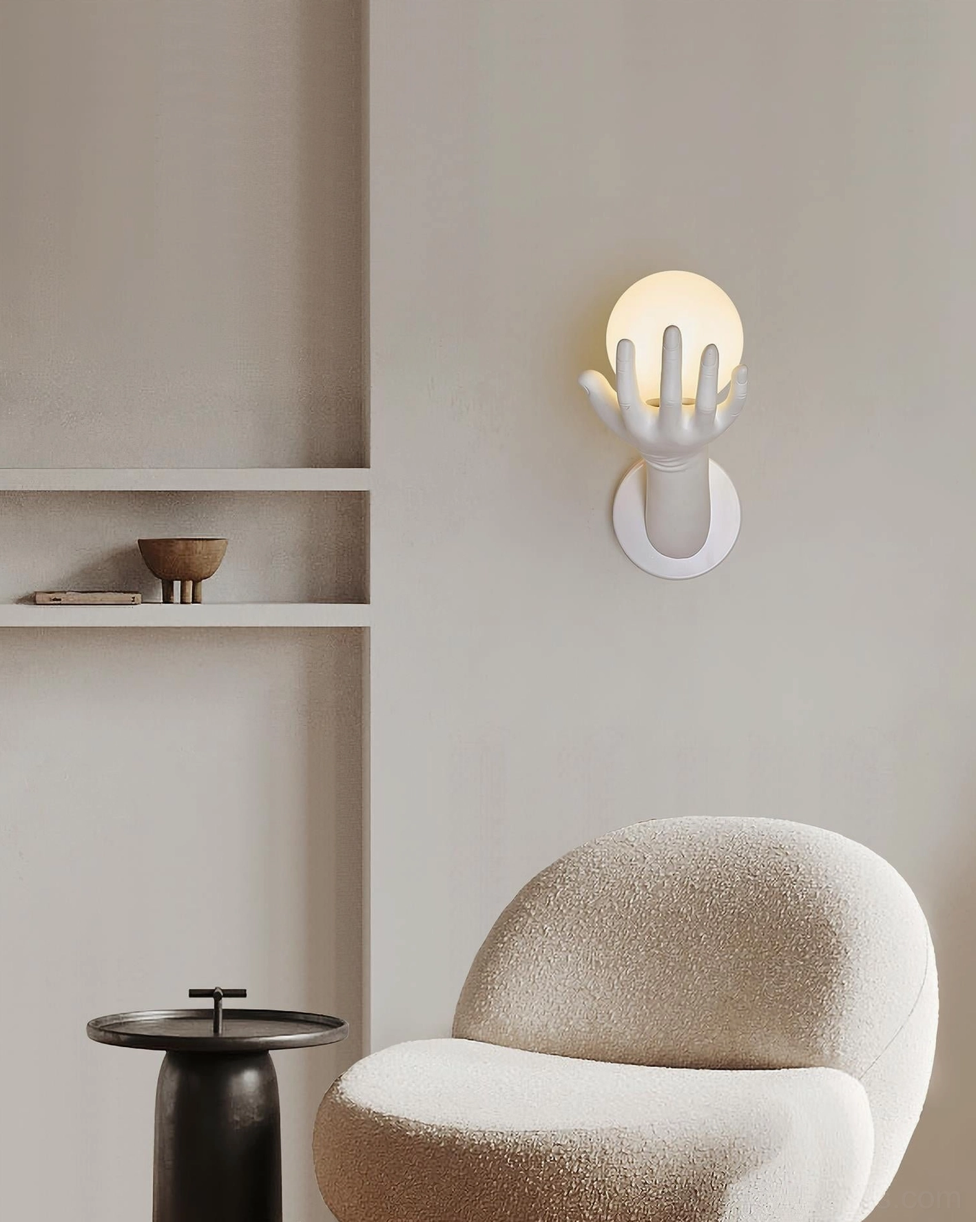 Hand of Victory wall sconce installed on light gray minimalist living room wall with boucle chair