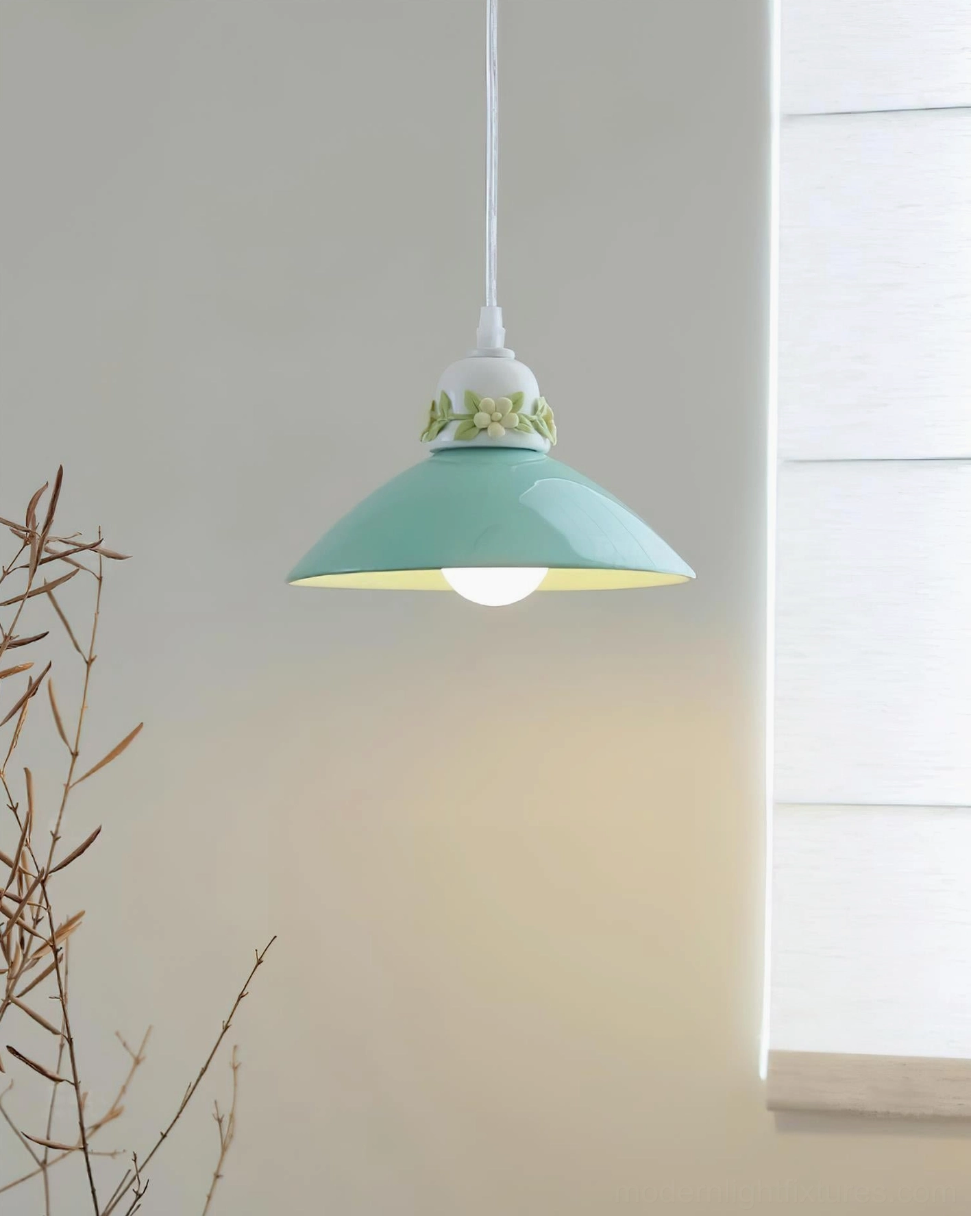 Mint green hand-painted ceramic conical pendant light with exposed LED, green botanical floral trim, window interior display