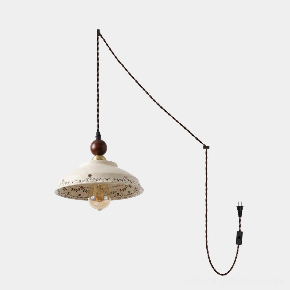 Hand-painted ceramic plug-in pendant light with cream stoneware shade, brown vine and red berry motif, walnut wood bead, brass socket, front view studio shot
