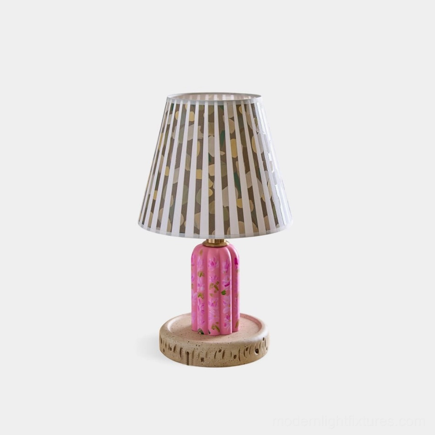 Hand-painted floral ceramic table lamp with pink botanical design and pleated striped fabric shade, front studio view on white background