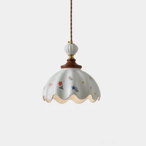 Hand-painted scalloped ceramic pendant light with multicolor floral design on white gloss, front studio view showing fluted ribbed shade and scalloped edge