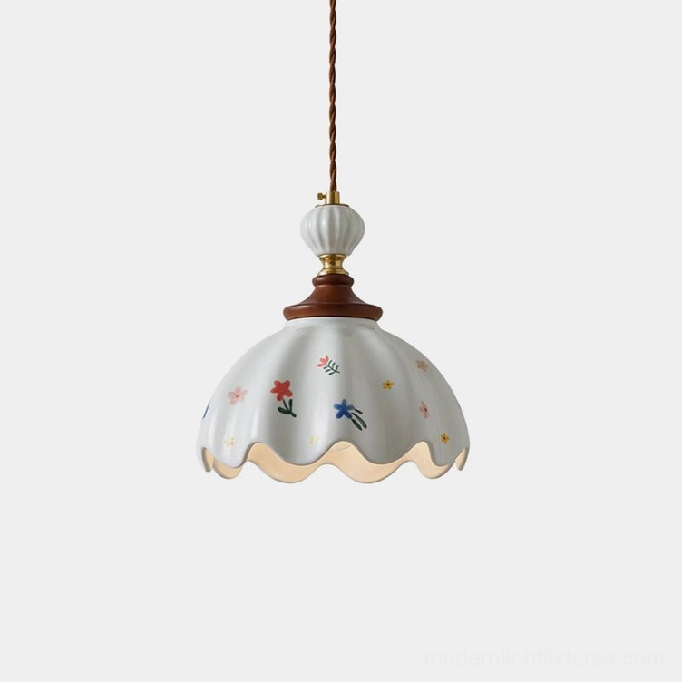 Hand-painted scalloped ceramic pendant light with multicolor floral design on white gloss, front studio view showing fluted ribbed shade and scalloped edge