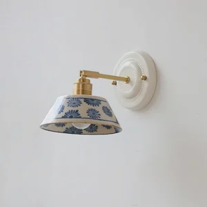Handcrafted blue and white porcelain wall sconce with delicate floral motifs, right front angle