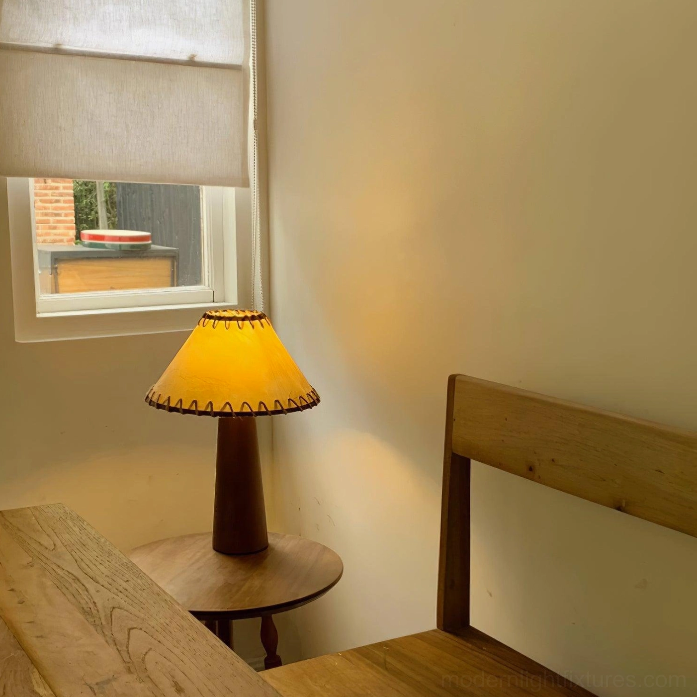 Hand-stitched jute shade lamp with solid wood base in japandi-inspired minimalist bedroom setting