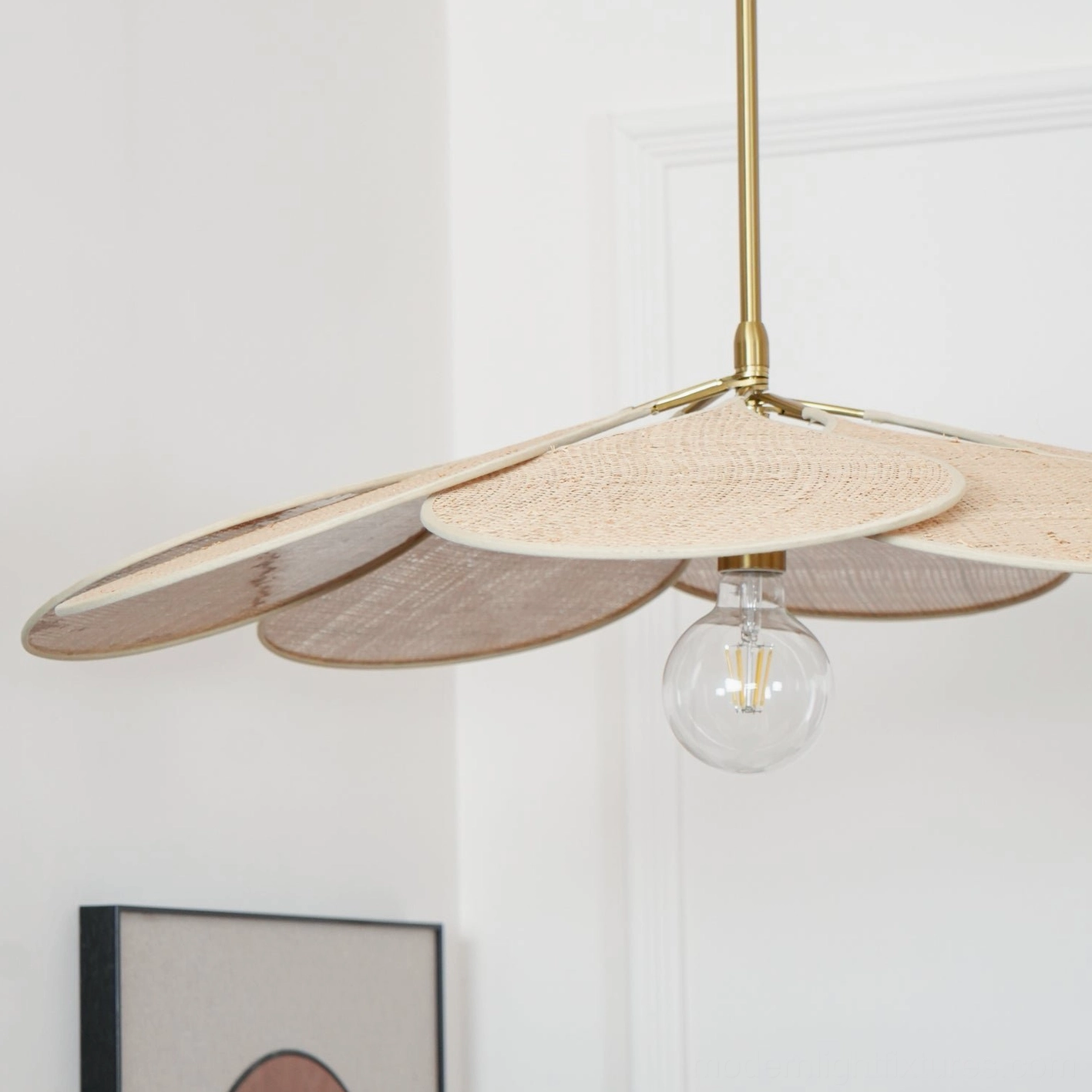 Hand-woven rattan bloom pendant with thick textured petals and brass hardware side view